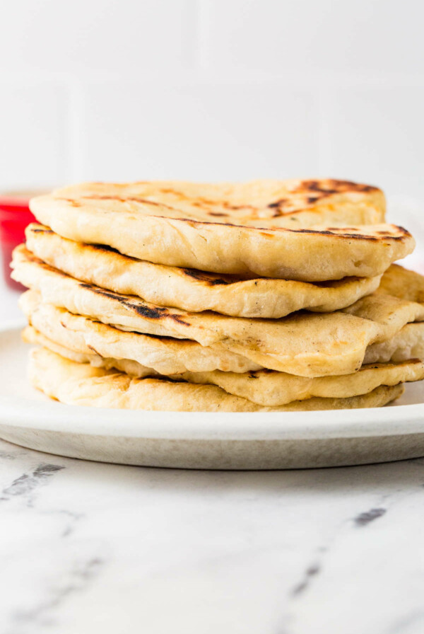 A stack of sourdough flatbread on a plate.