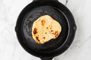 Sourdough flatbread in a skillet.
