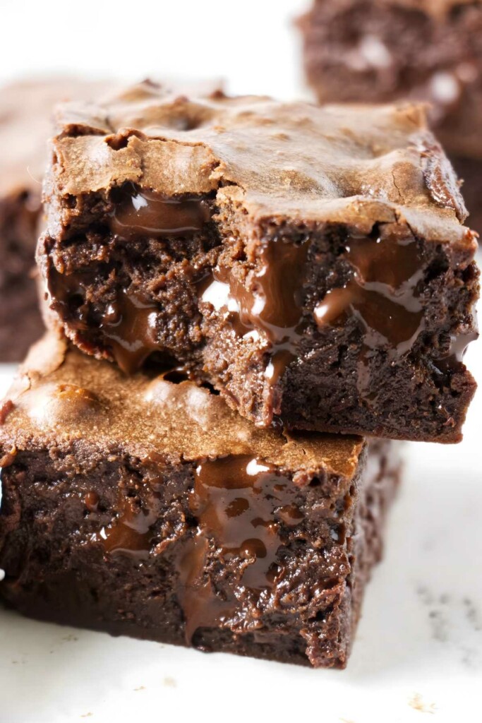 Two condensed milk chocolate brownies with melted chocolate.