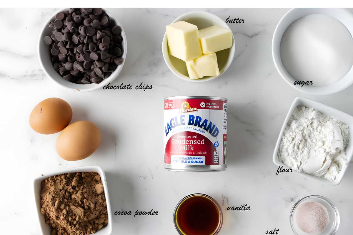Top-down view of labeled baking ingredients arranged on a white surface.