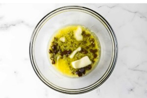Glass bowl with melted butter and chocolate.