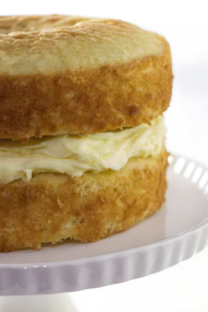 Vanilla mousse cake filling between two layers of cake.