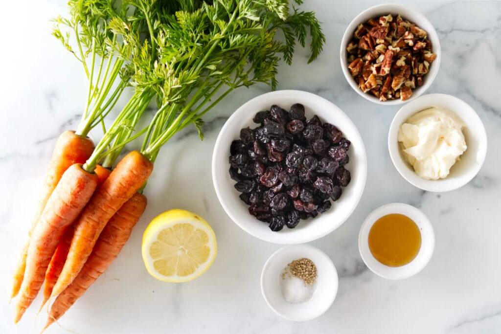 Ingredients used to make a carrot and raisin salad.
