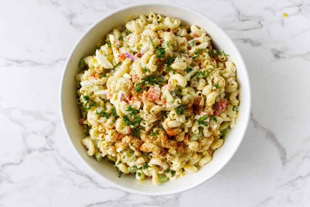 An old fashioned macaroni salad with paprika on top.