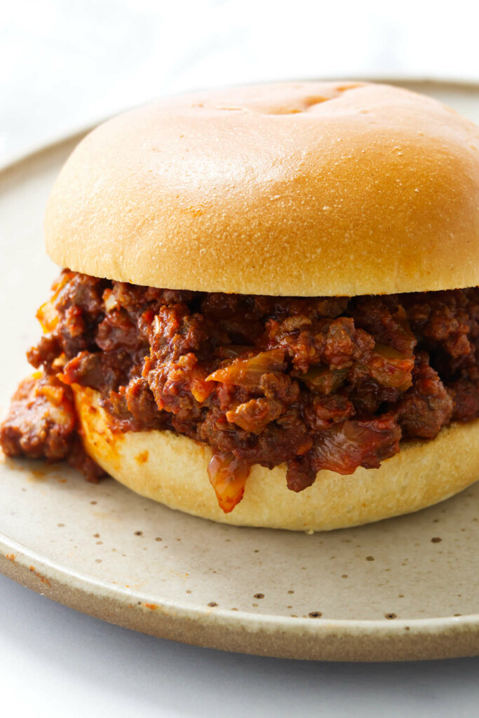 A homemade sloppy joes sauce piled between burger buns.