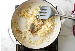 Cooking onions and aromatics in a skillet.