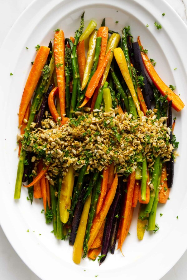 A carrot and asparagus recipe on a white serving platter.