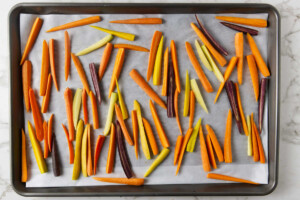 Sliced carrots on a baking sheet.