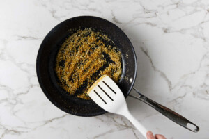 Toasting panko breadcrumbs in a skillet.