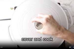 Covering the skillet to cook.