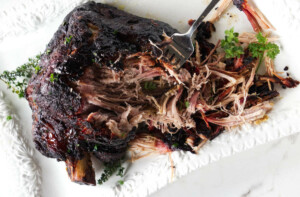 Shredding roasted pork shoulder for tamales.