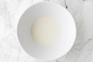 combining sourdough discard with milk and sour cream.