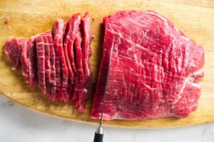 Slicing a flank steak across the grain.
