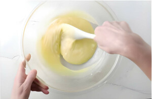 Stirring the melted white chocolate and cream together.