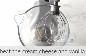 Beating cream cheese in a bowl.
