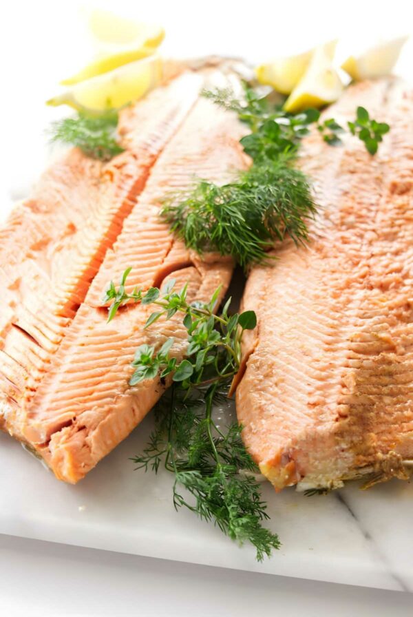 A whole baked salmon on a serving platter.