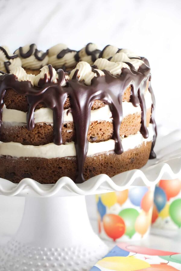 Layered chocolate chip cookie cake with cream and ganache.