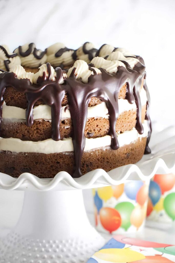 Layered chocolate chip cookie cake with cream and ganache.