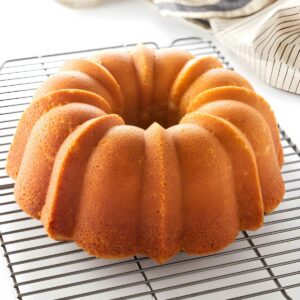 Golden-brown pound cake on cooling rack.