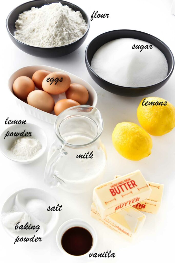 Assorted baking ingredients including flour, eggs, lemons, milk, butter, and vanilla.