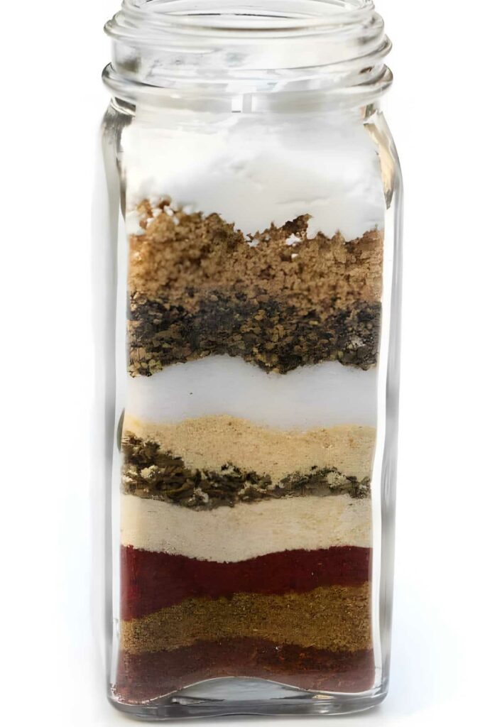 Glass jar with layered, Mexican spices.