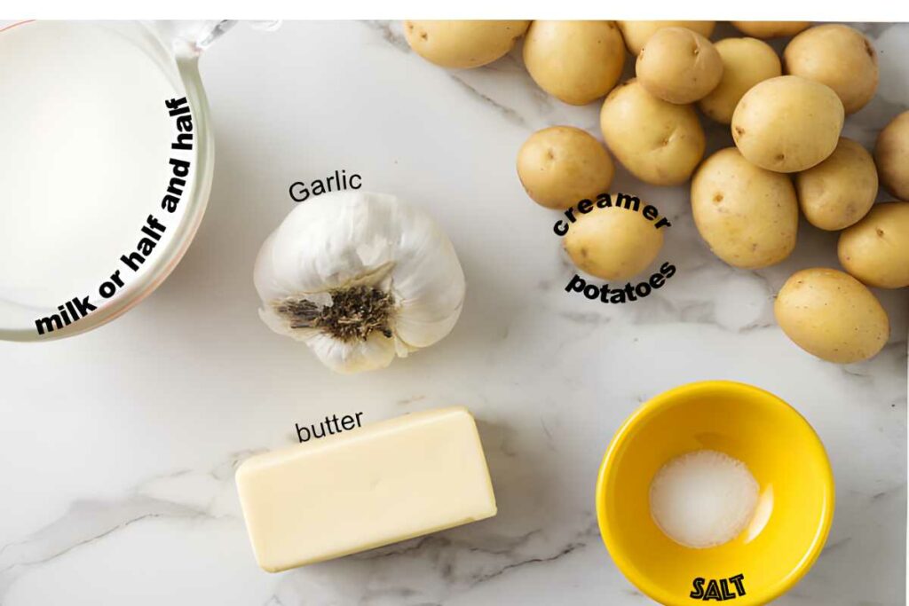 Overhead of labeled potatoes, garlic, butter, salt bowl, and milk cup.