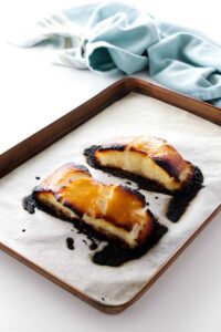 Two miso glazed sea bass fish fillets on parchment.