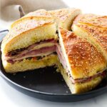 A pressed muffuletta sandwich on a platter.