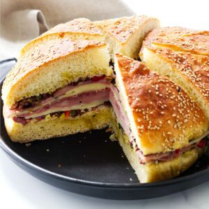 A pressed muffuletta sandwich on a platter.