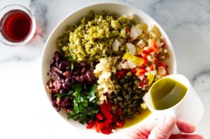 making an olive salad for a sandwich.
