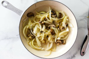 Cooking onions and mushrooms for steak and cheese recipe.
