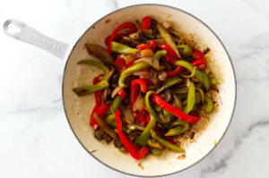 Cooking bell peppers for philadelphia cheese steak sandwich.