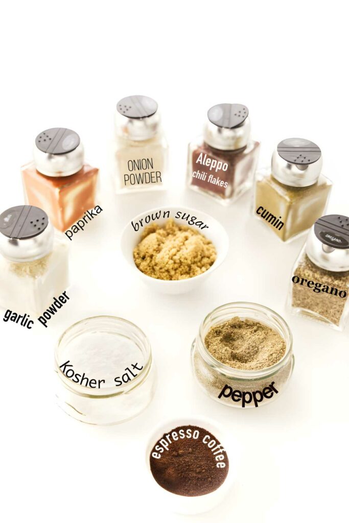 Eight labeled spice jars with bowls of brown sugar and espresso coffee.