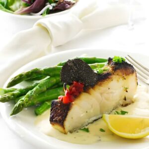 Seared sea bass fillet with truffle, peppers, asparagus and salad.