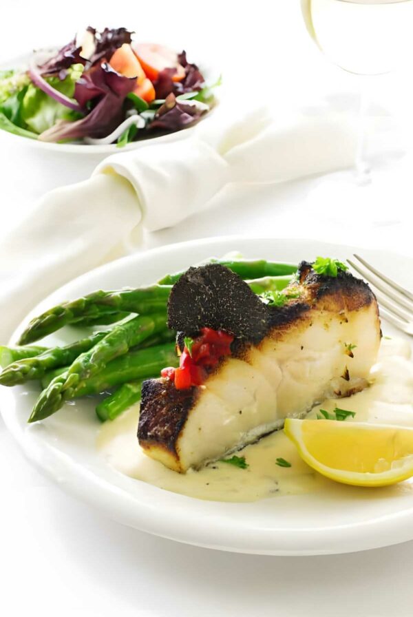 Seared sea bass fillet with truffle, peppers, asparagus and salad.