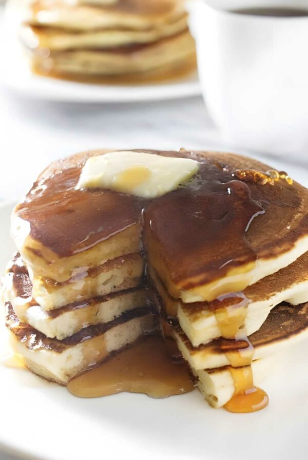 Stack of sourdough ricotta pancakes with butter.