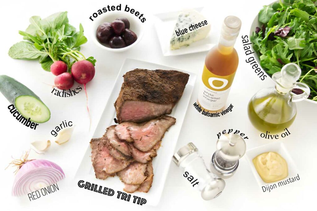 Overhead view of assorted salad ingredients arranged in bowls and plates.