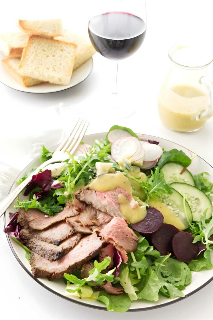 Steak salad made with tri tip and with greens and vegetables.
