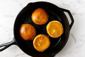 Toasting burger buns in a skillet.