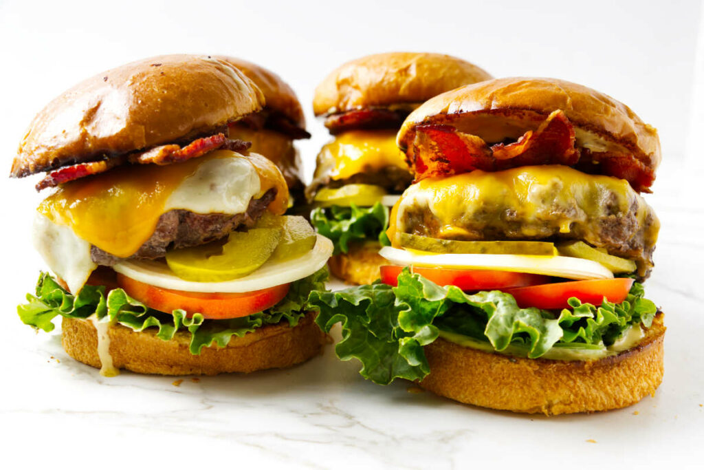 Four bacon cheeseburgers with all the fixings.