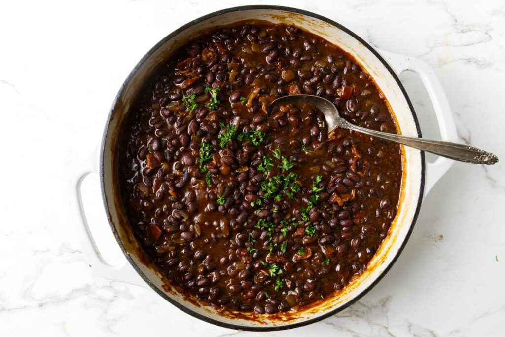 BBQ black beans in a pan on the stovetop.
