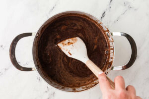 Stirring chocolate into warm milk mixture.
