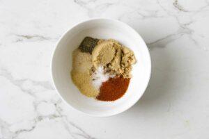 blending spices and brown sugar in a bowl.