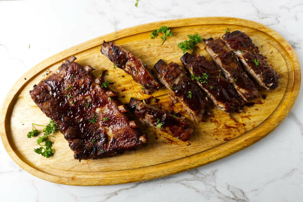 BBQ ribs on a cutting board.