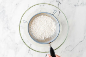 Adding the dry ingredients to the bowl.