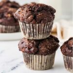 Two sourdough chocolate muffins stacked on top of each other.