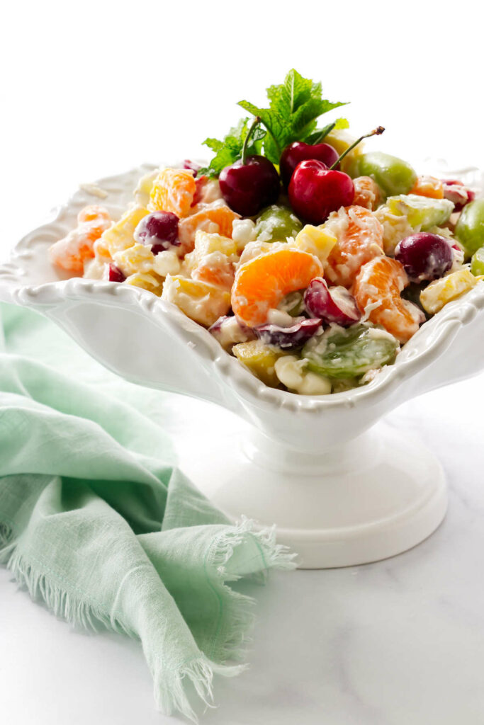 Fresh fruit ambrosia salad in a white dish.