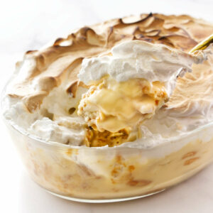 Traditional banana pudding topped with meringue in a glass dish.