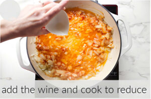 Deglazing the pan with wine.