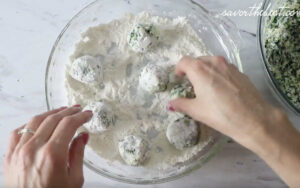 rolling ricotta and spinach dumplings in flour.